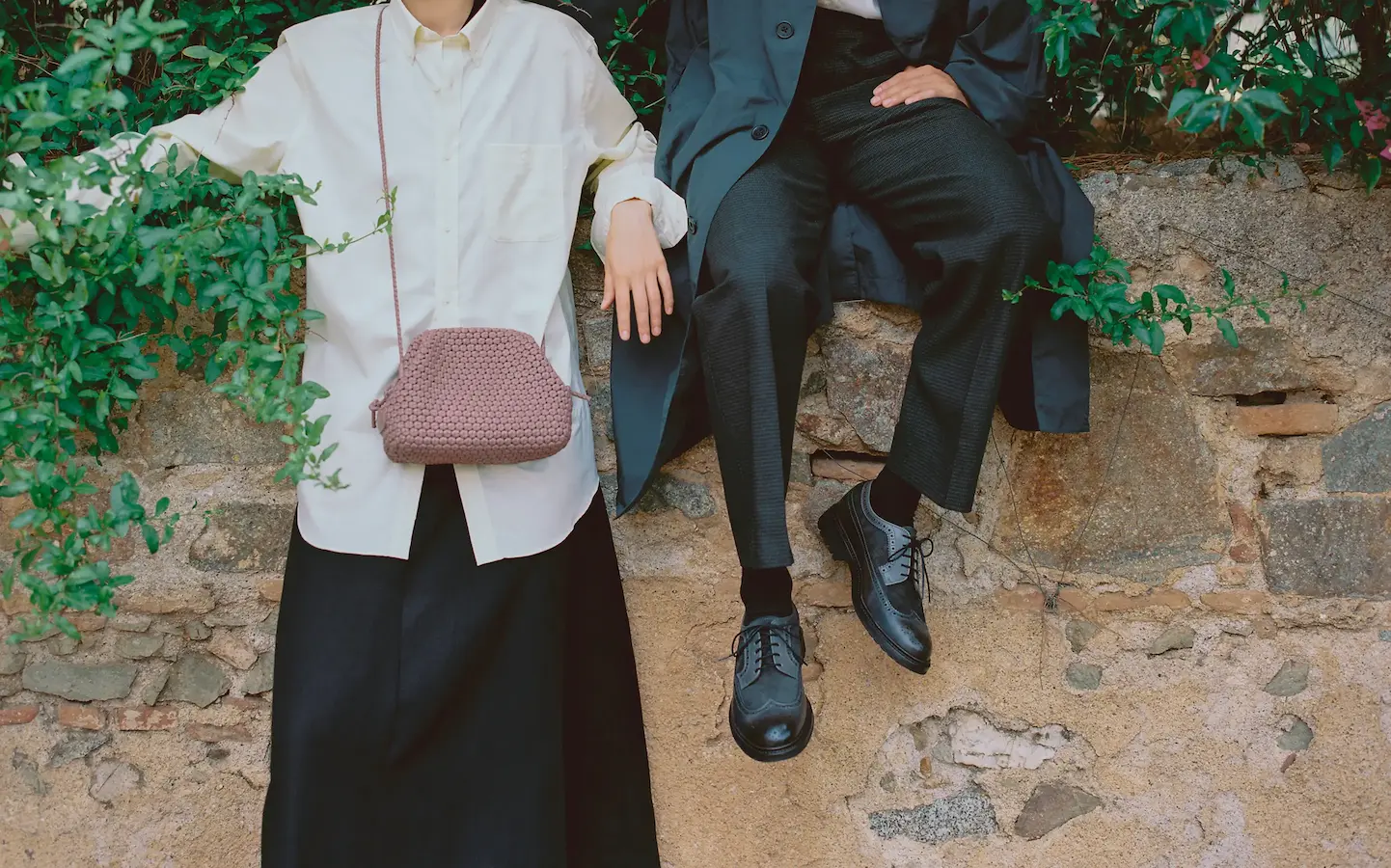 man and woman leaning on a wall